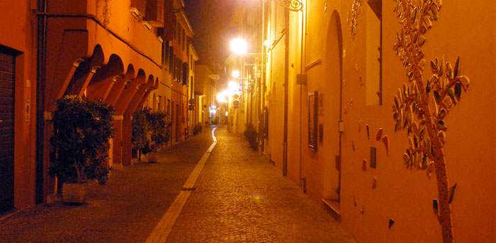 Via Garibaldi at night and the “ocarina tree“ on the facade of the Ocarina Museum